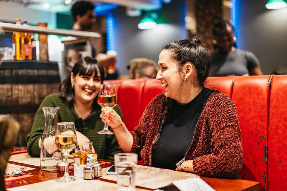 Edinburgh: Scottish Dinner and Folk Music Experience - Bagpipe Welcome Outside Biblos: Your Night Starts Fast